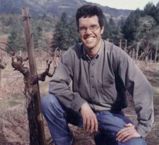 Hugh Davies as a young vintner in 1999, kneeling by vines at Schramsberg in 1999.
