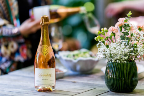 Schramsberg Brut Rosé on a table, and being poured into a wine glass