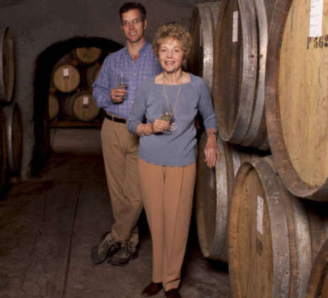 Hugh Davies and his mother, Schramsberg matriarch Jamie Davies, pose in front of wine barrels at the winery in 2005