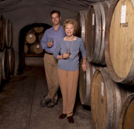 Hugh Davies and his mother, Schramsberg matriarch Jamie Davies, pose in front of wine barrels at the winery in 2005