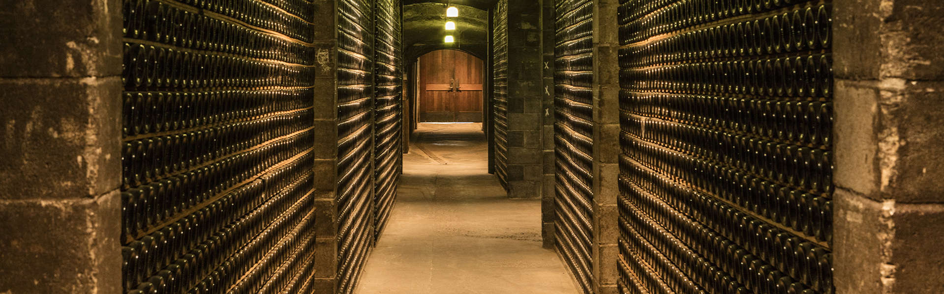Corridor stacked with fermenting sparkling wine bottles in Schramsberg historic wine caves