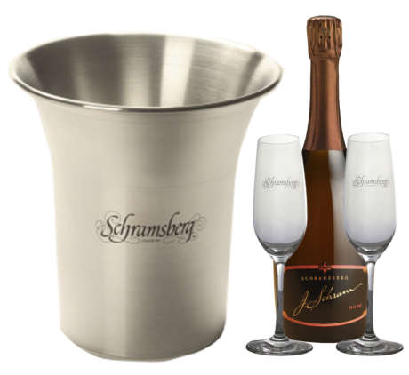 One stainless steal Schramsberg logo ice bucket and a bottle of J. Schram Rosé along with two etched Schramsberg flutes.