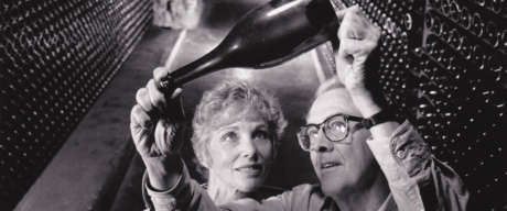 Schramsberg's founder and patriarch, Jack Davies, holds up a sparkling wine bottle to inspect fermentation with Jamie Davies in the historic wine caves, circa 1980