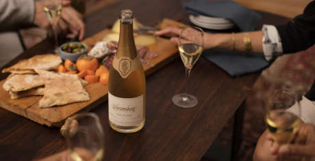 Coffee table gathering with Schramsberg Blancs de Noirs sparkling wine paired with a charcuterie board.