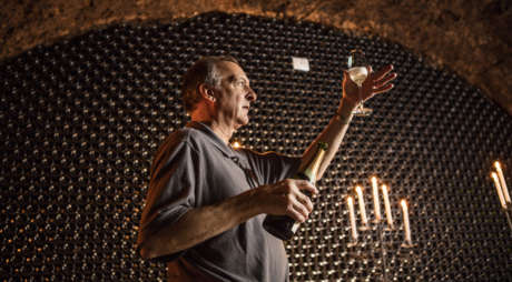 Wine educator with Blanc de Blancs in the wine caves