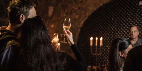 Guests enjoying Schramsberg sparkling wine by candelight in historic wine caves