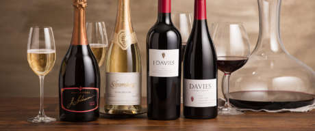 Display of J. Schram Rosé, Blanc de Noirs, J. Davies Estate Cabernet Sauvignon and Davies Vineyards Pinot Noir with glasses and wine carafe