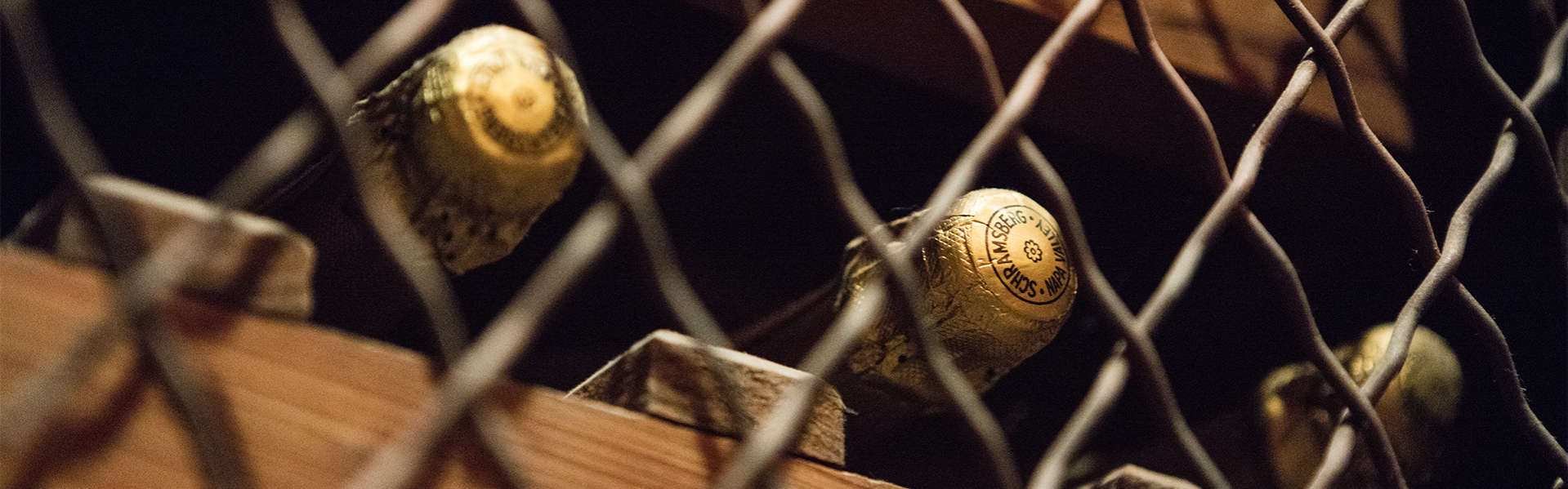 Schramsberg sparkling wine stored on wine racks in the Davies room at visitors center