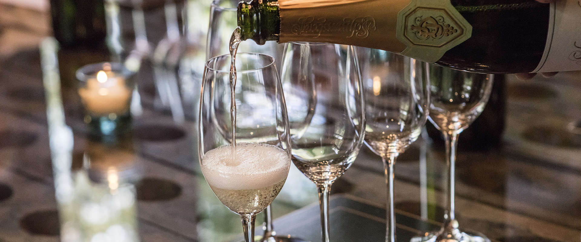 Schramsberg Blanc de Blancs sparkling wine being poured into sparkling wine glasses for a sit down tasting in the visitor's center