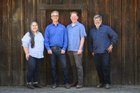 The winemaking team standing at the barn