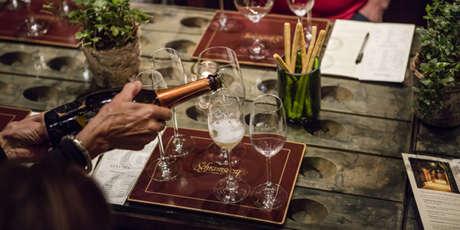 Schramsberg sparkling wine being poured into glasses for a seated tasting in the visitors center.